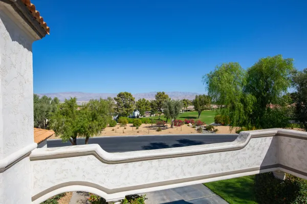 a view of a street with cars parked on road