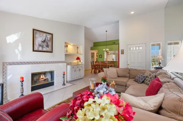 a living room with furniture fireplace and a large window