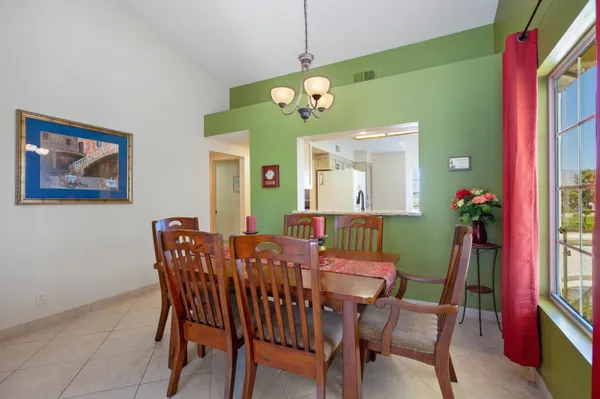 a view of a dining room with furniture and window