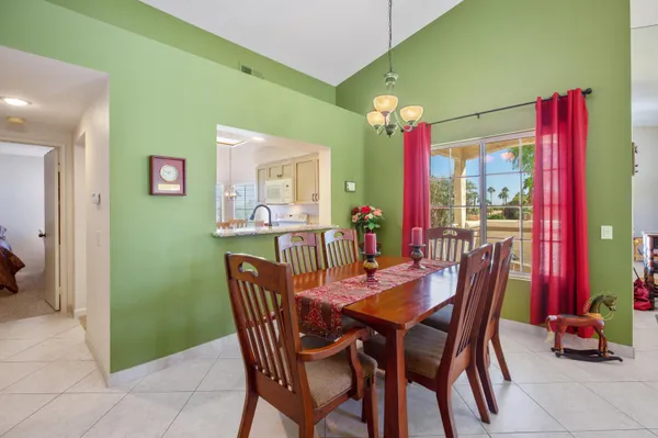 a view of a dining room with furniture and a chandelier