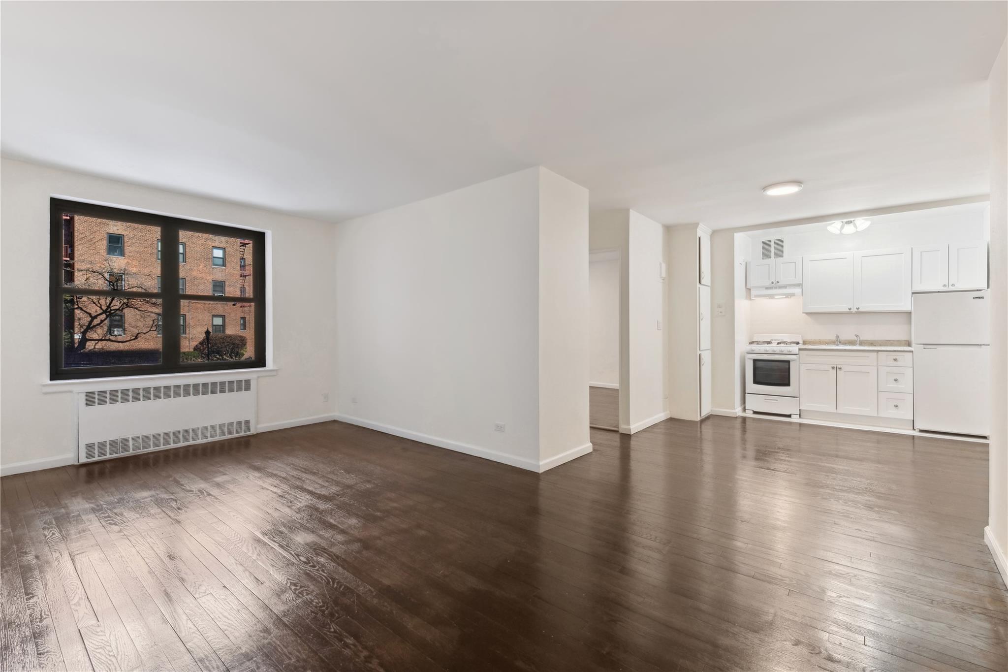 100-11 67th Road, Unit 108 Queens, NY 11375 - Photo 1 of 1 View of living room to dining and kitchen