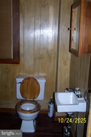 a bathroom with a toilet and a mirror