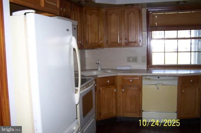 a kitchen with a refrigerator and a sink