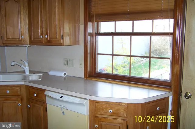 a kitchen with a window and cabinets