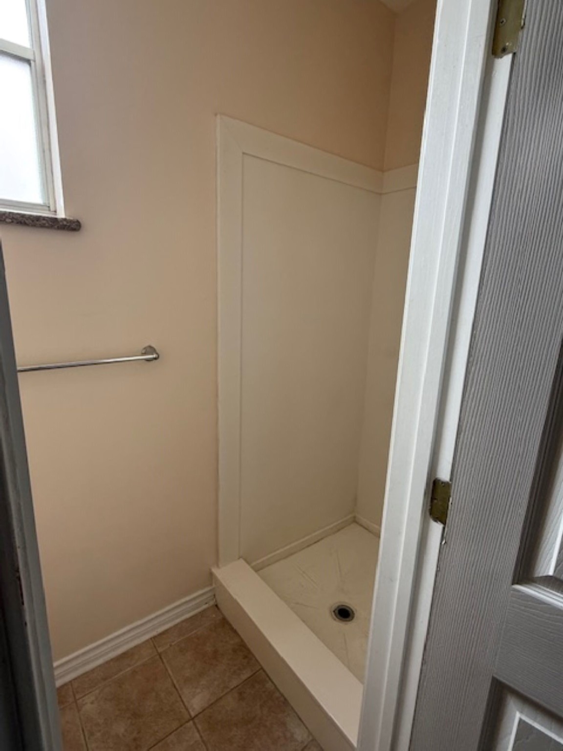 702 Staitti Street, Unit C Humble, TX 77338 - Photo 12 of 14 a bathroom with a glass shower door