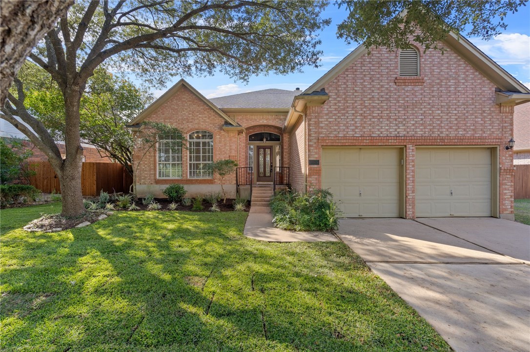 10536 Redmond Road Austin, TX 78739 - Photo 1 of 1 a front view of a house with a yard and garage