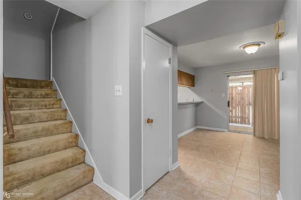 an empty room with a fireplace and a chandelier fan