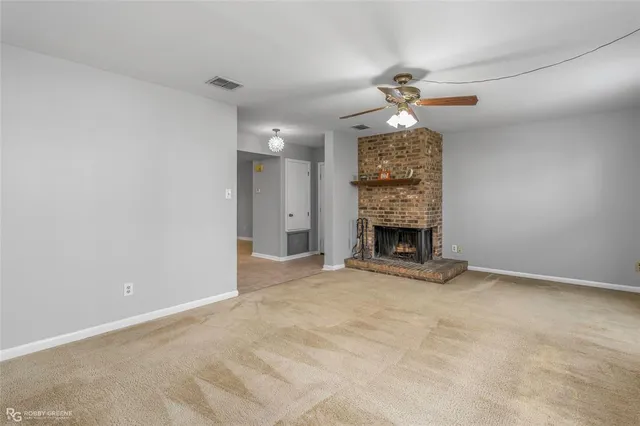an empty room with closet and fan
