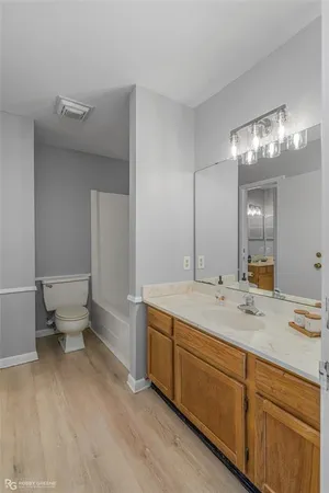 a white bath tub sitting next to a toilet