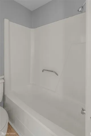 a view of an empty room with a ceiling fan