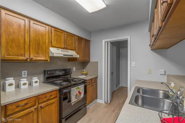 a kitchen with stainless steel appliances granite countertop a sink and cabinets