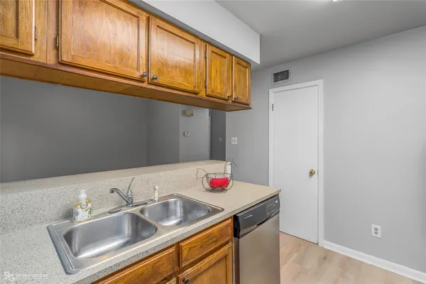 a kitchen with stainless steel appliances granite countertop a sink and a cabinets
