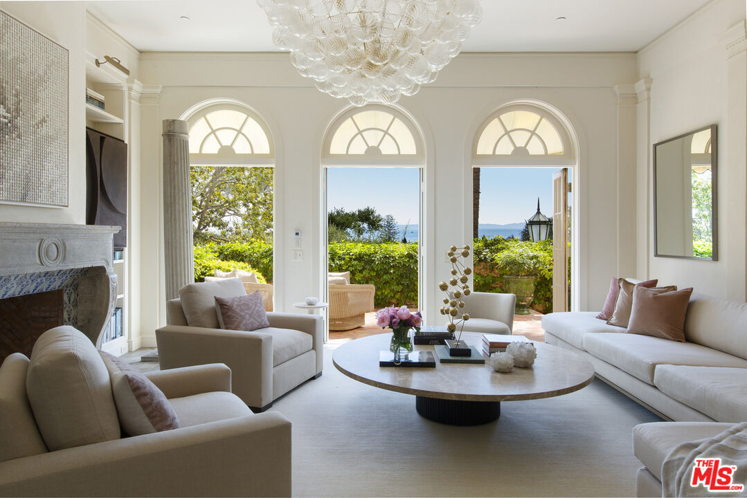 670 Hot Springs Road Montecito, CA 93108 - Photo 11 of 36 a living room with fireplace furniture and a large window