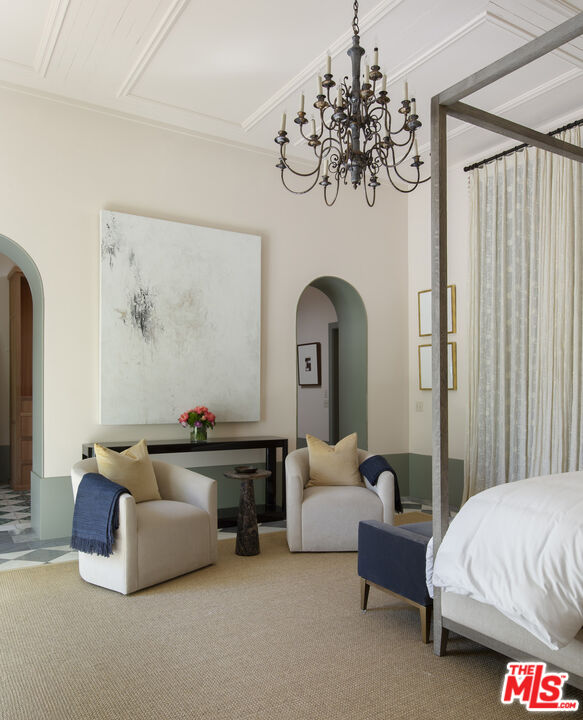 670 Hot Springs Road Montecito, CA 93108 - Photo 26 of 36 a spacious bedroom with bed and a chandelier