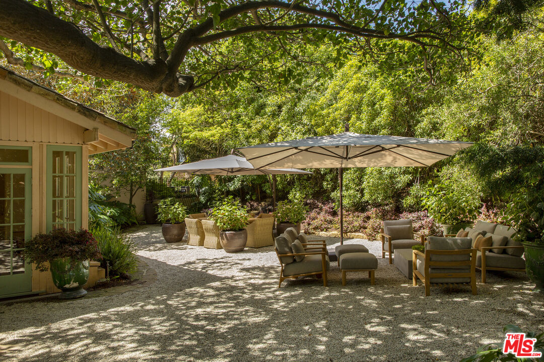 670 Hot Springs Road Montecito, CA 93108 - Photo 30 of 36 a view of a patio with table and chairs under an umbrella