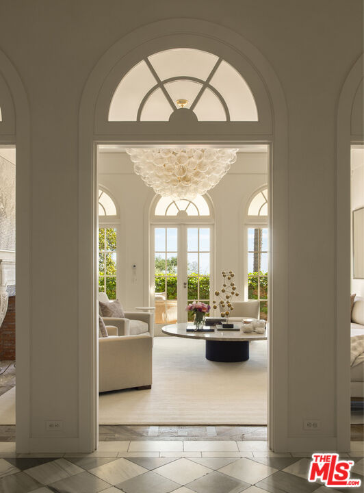 670 Hot Springs Road Montecito, CA 93108 - Photo 10 of 36 a living room with a large window and chandelier