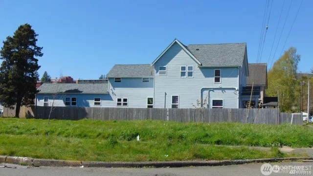 a view of a house with a yard and sitting area