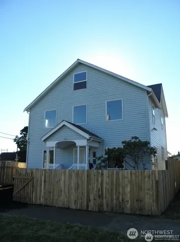 a view of a house with wooden fence