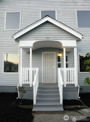 a front view of a house with a garden and patio
