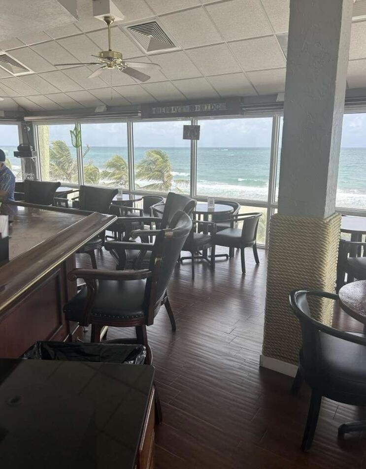 111 Briny Avenue, Unit 703 Pompano Beach, FL 33062 - Photo 18 of 19 a dining room with furniture window and wooden floor