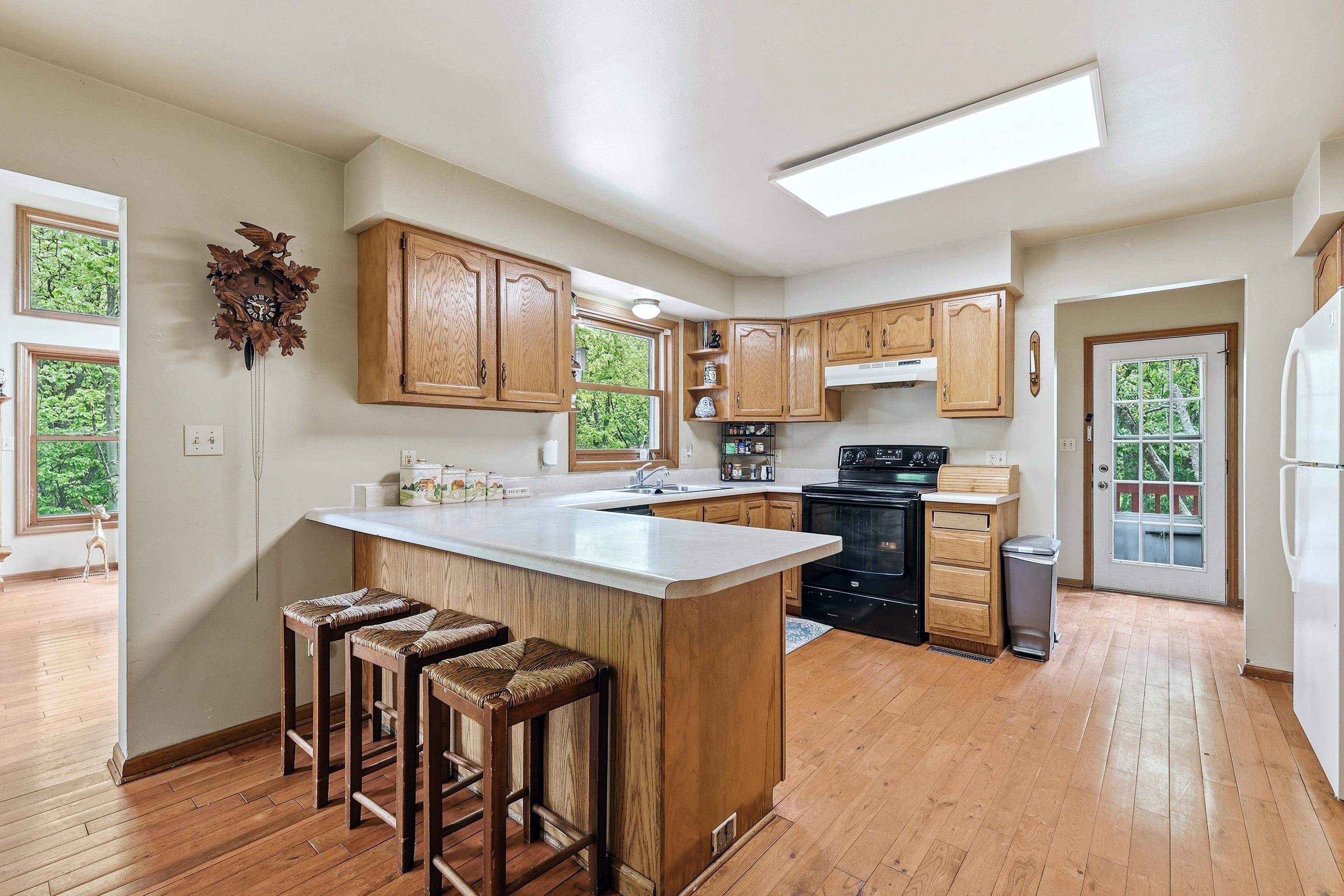 13 Signal Point Lane Galena, IL 61036 - Photo 15 of 47 a kitchen with a table chairs a sink dishwasher stove and cabinets with wooden floor