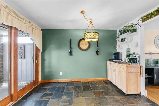 a kitchen with stainless steel appliances granite countertop a sink and a black refrigerator