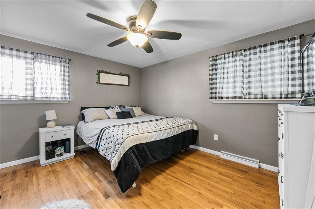 708 Hancock Street Perryopolis, PA 15473 - Photo 14 of 36 a bedroom with a large bed and a chandelier