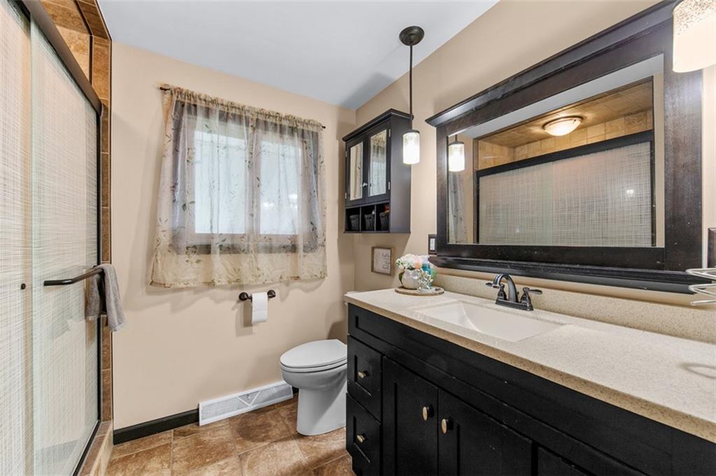 708 Hancock Street Perryopolis, PA 15473 - Photo 16 of 36 a bathroom with a double vanity sink a mirror and a toilet