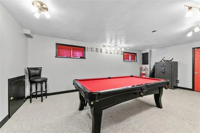 a room with pool table and a flat screen tv