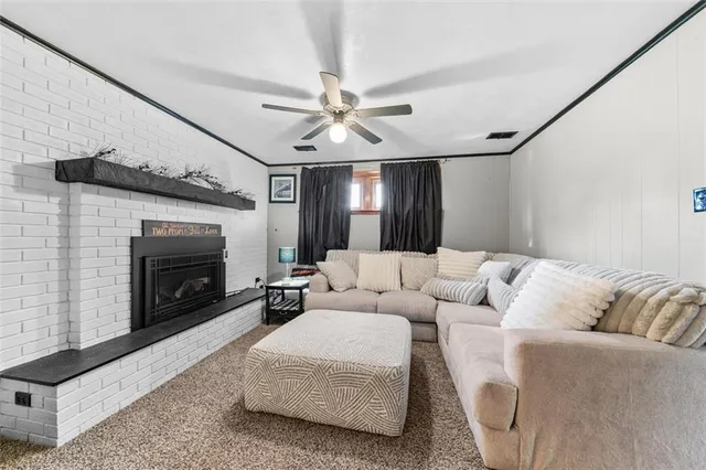 a living room with furniture and a fireplace