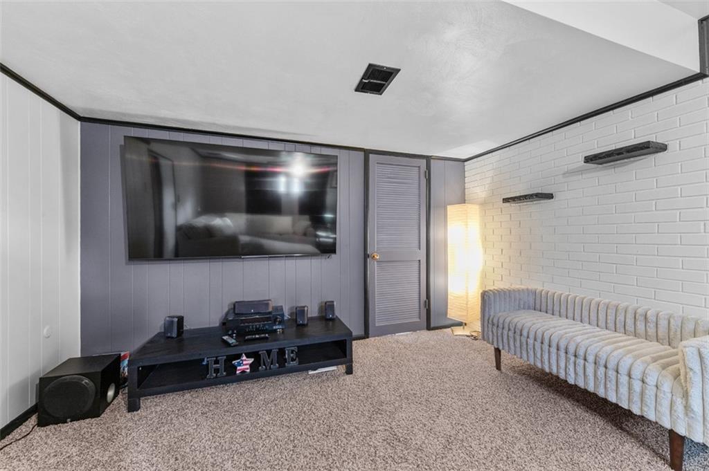 708 Hancock Street Perryopolis, PA 15473 - Photo 27 of 36 a living room with a couch and a flat screen tv