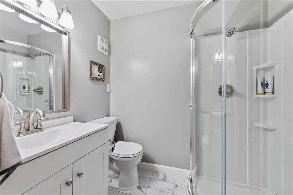 708 Hancock Street Perryopolis, PA 15473 - Photo 28 of 36 a bathroom with a toilet sink a shower and a mirror