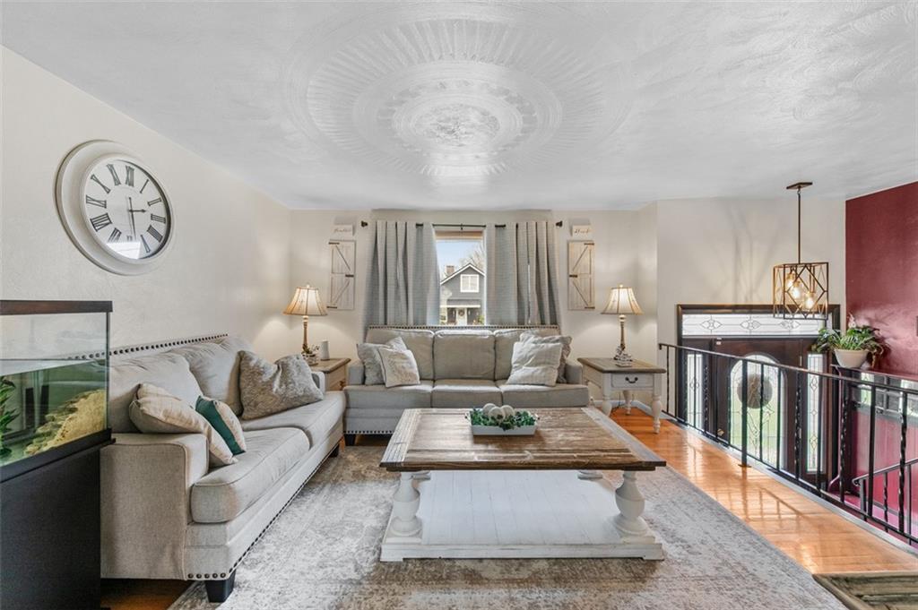 708 Hancock Street Perryopolis, PA 15473 - Photo 3 of 36 a living room with furniture a clock on wall and a table