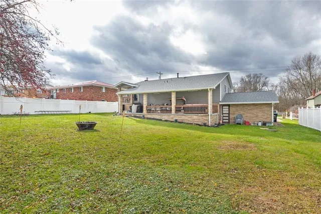 a view of a house with a backyard and a patio