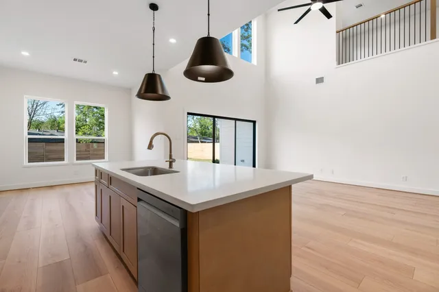 a kitchen with a stove and a wooden floor