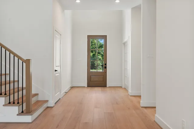 a view of an empty room with wooden floor