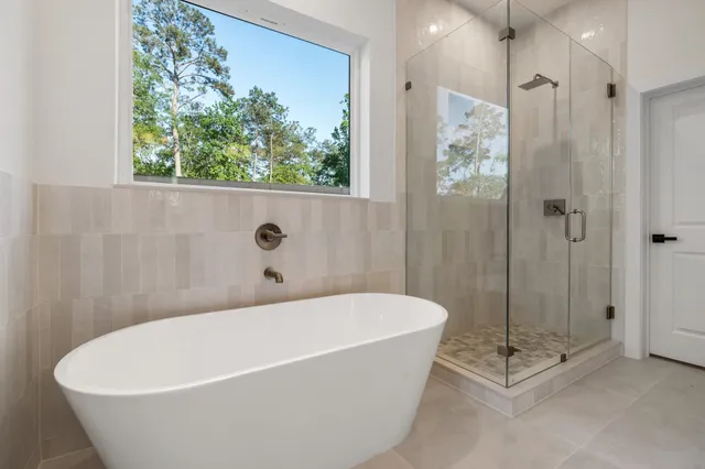 a white bath tub sitting next to a shower