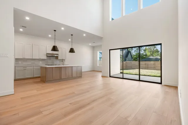 a view of a kitchen with large windows