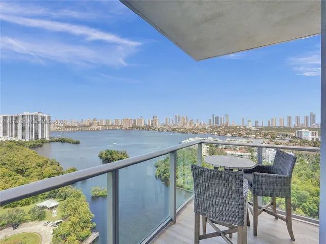 a view of a balcony with wooden floor and outdoor seating