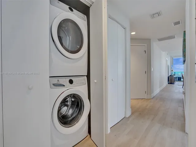 a view of a hallway with washer and dryer
