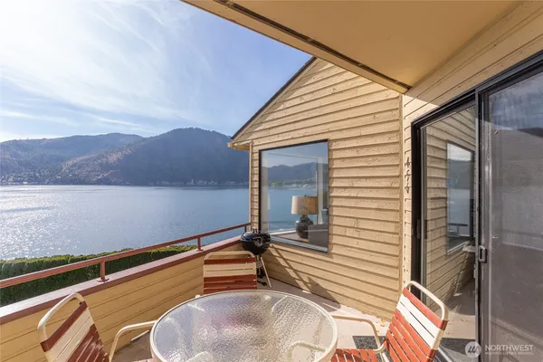 a backyard of a house with lake view and a large window