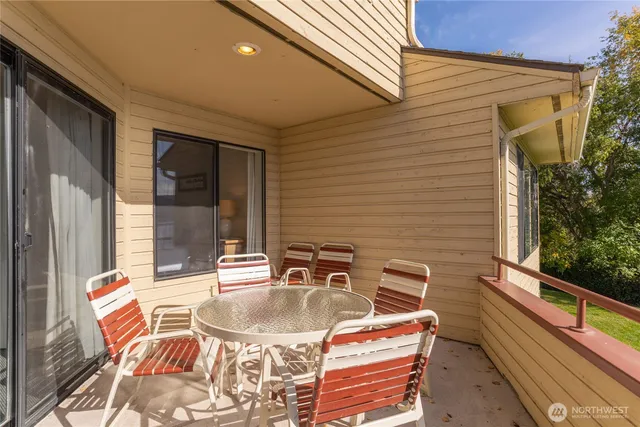 a backyard of a house with table and chairs