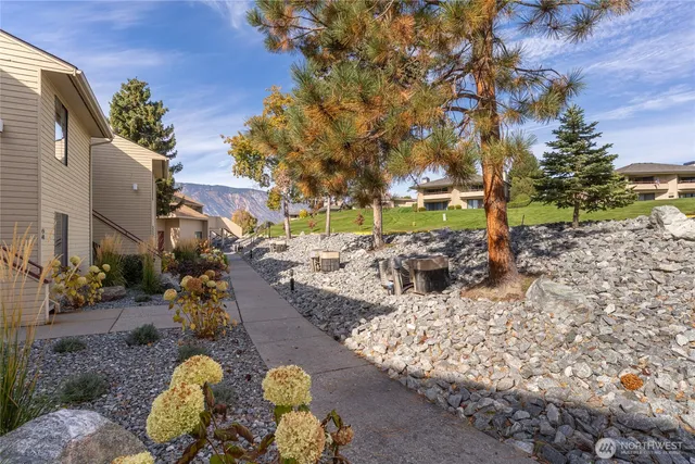 a front view of a house with plants