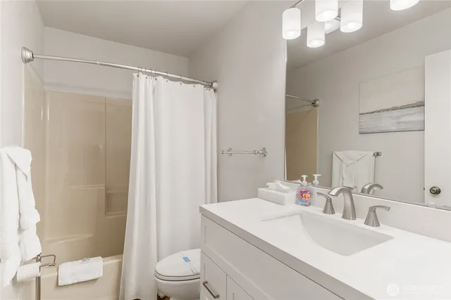 a bedroom with two beds and a large window