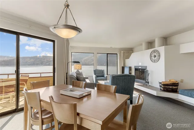 a view of a dining room with furniture and a large window
