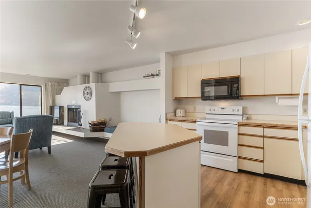 a kitchen with a sink appliances and cabinets