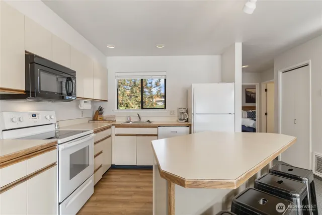 a kitchen with a stove a sink and a refrigerator