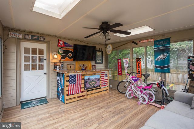 a bedroom with furniture a ceiling fan and a window