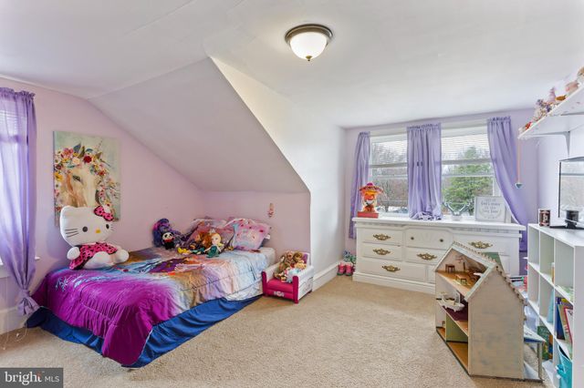 a bedroom with bed and a window