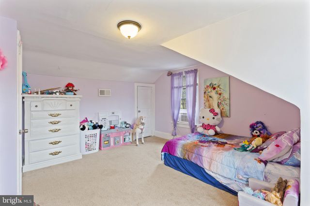 a bedroom with toys and a couch